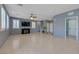 Large living room with tile floors, plantation shutters, and staircase at 599 Wounded Star Ave, Las Vegas, NV 89178