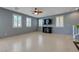 Spacious living room with tile floors, modern ceiling fan, and plantation shutters at 599 Wounded Star Ave, Las Vegas, NV 89178