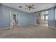 Bright main bedroom with an ensuite bathroom featuring a barn door and hardwood-style floors at 599 Wounded Star Ave, Las Vegas, NV 89178