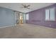 Spacious main bedroom with ensuite bathroom featuring a barn door and a ceiling fan at 599 Wounded Star Ave, Las Vegas, NV 89178