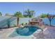 Inviting pool area with a rock waterfall feature and surrounding patio, perfect for relaxation at 599 Wounded Star Ave, Las Vegas, NV 89178