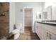 Well-lit bathroom with neutral-toned tile shower, toilet, and double sink vanity at 6006 Vegas Dr, Las Vegas, NV 89108