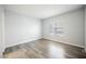 Serene bedroom filled with natural light from the window and light wood-look flooring at 6006 Vegas Dr, Las Vegas, NV 89108