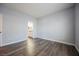 Spacious bedroom with light wood flooring and neutral walls adjacent to the bathroom at 6006 Vegas Dr, Las Vegas, NV 89108