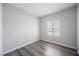 Bedroom with wood floor, window with blinds and neutral paint at 6006 Vegas Dr, Las Vegas, NV 89108