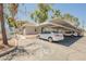 Exterior view of Rock Creek Manor, featuring covered parking, desert landscaping, and a community sign at 6006 Vegas Dr, Las Vegas, NV 89108