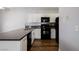 Charming kitchen with white cabinets, black appliances, tile backsplash, and sleek countertops at 6006 Vegas Dr, Las Vegas, NV 89108