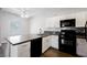 Well-lit kitchen features white cabinets, modern appliances, stylish backsplash, and countertops with breakfast bar at 6006 Vegas Dr, Las Vegas, NV 89108