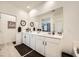 Bathroom featuring a double vanity with white countertops and dark hardware, complemented by stylish wall decor at 6098 Avery Pointe St, Las Vegas, NV 89166
