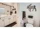 Modern bathroom with white vanity, granite countertop, decorative moose, and a cozy brown accent rug at 6098 Avery Pointe St, Las Vegas, NV 89166