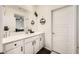 Bright bathroom featuring white cabinetry, a quartz countertop, and mountain-themed décor at 6098 Avery Pointe St, Las Vegas, NV 89166