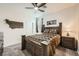 Cozy bedroom featuring a comfortable bed, rustic decor, and a ceiling fan, ideal for relaxation and restful nights at 6098 Avery Pointe St, Las Vegas, NV 89166