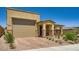 Charming single-Gathering home featuring a two-car garage, beautiful brick driveway and desert landscaping at 6098 Avery Pointe St, Las Vegas, NV 89166