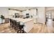 Bright kitchen with white cabinets, a spacious island with seating, and stainless steel appliances at 6098 Avery Pointe St, Las Vegas, NV 89166