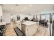 Open-concept kitchen with stainless steel appliances and quartz countertops overlooks the dining and living areas at 6098 Avery Pointe St, Las Vegas, NV 89166