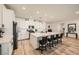 Bright kitchen features white cabinets, a large center island with seating and modern stainless steel appliances at 6098 Avery Pointe St, Las Vegas, NV 89166