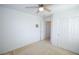 Bedroom with a ceiling fan, closet, plush carpet, and neutral color palette at 6098 Darkfeather Way, Las Vegas, NV 89139