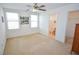 Spacious bedroom featuring a ceiling fan, carpet flooring, and bright windows at 6098 Darkfeather Way, Las Vegas, NV 89139