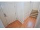 Bright foyer with wood laminate flooring, a closet, and carpeted stairs at 6098 Darkfeather Way, Las Vegas, NV 89139
