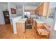 Bright kitchen with stainless steel appliances, breakfast bar, and laminate floors at 6098 Darkfeather Way, Las Vegas, NV 89139