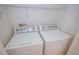 Convenient laundry room with a white, front-loading washer and dryer at 6098 Darkfeather Way, Las Vegas, NV 89139