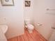 Cozy powder room features wood-look flooring and classic fixtures at 6098 Darkfeather Way, Las Vegas, NV 89139