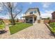 Landscaped backyard featuring artificial turf, a patio, and a paved walkway at 648 Jumbled Sage Ct, Henderson, NV 89015