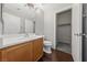 Bright bathroom with vanity and adjacent walk-in closet with carpet at 648 Jumbled Sage Ct, Henderson, NV 89015