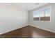 Bright bedroom featuring wood floors, white walls, and a window with blinds at 648 Jumbled Sage Ct, Henderson, NV 89015