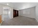 Bonus room featuring carpet, large window with blinds, and built-in shelving at 648 Jumbled Sage Ct, Henderson, NV 89015