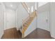 Welcoming foyer with staircase, wood flooring, and a white front door at 648 Jumbled Sage Ct, Henderson, NV 89015