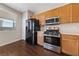 Well-lit kitchen features stainless steel oven, microwave, and refrigerator at 648 Jumbled Sage Ct, Henderson, NV 89015