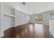 Bright living room featuring wood floors, white walls, and sliding glass doors at 648 Jumbled Sage Ct, Henderson, NV 89015