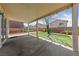 Covered patio and artificial turf area with a brick wall and views of neighboring homes at 648 Jumbled Sage Ct, Henderson, NV 89015