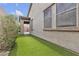 Backyard has artificial grass, stucco walls and a covered patio area at 660 Otter Brook St, Henderson, NV 89011