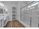 Modern bathroom with double vanity, glass shower, and wood-look tile flooring at 660 Otter Brook St, Henderson, NV 89011