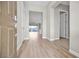 View of the foyer leading to a bright living space with hardwood floors and neutral walls at 665 Look Lively Ct, Henderson, NV 89011