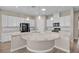 Bright kitchen with white cabinets, granite countertops, stainless steel appliances, and large island at 665 Look Lively Ct, Henderson, NV 89011