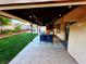 Inviting covered patio featuring lounge furniture and backyard views, alongside an outdoor bar area for entertaining at 6746 Shelter Ln, Las Vegas, NV 89103