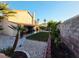 Expansive backyard showing well-manicured lawn, stone landscaping, mature trees, and a covered patio at 6746 Shelter Ln, Las Vegas, NV 89103