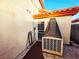 Exterior of home features a back door, with an air conditioning unit, along a stone pathway at 6746 Shelter Ln, Las Vegas, NV 89103