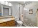 Modern bathroom with stone floors, a glass shower, and a granite-topped vanity at 6746 Shelter Ln, Las Vegas, NV 89103