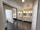 Well-lit bathroom featuring a double sink vanity, white cabinets, and tile floors at 6746 Shelter Ln, Las Vegas, NV 89103