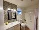 Full bathroom featuring stylish tile accents, well-lit mirror, and vanity storage at 6746 Shelter Ln, Las Vegas, NV 89103
