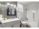 Well-lit bathroom with modern tile accents, a shower-tub combination, and a sleek vanity at 6746 Shelter Ln, Las Vegas, NV 89103
