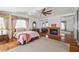 Spacious bedroom with a fireplace, mirrored closet doors, and elegant furnishings at 6746 Shelter Ln, Las Vegas, NV 89103