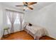 Cozy bedroom features hardwood floors, a ceiling fan, and a twin bed, great for children or guests at 6746 Shelter Ln, Las Vegas, NV 89103