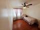 Cozy bedroom with hardwood floors, natural lighting, and a ceiling fan at 6746 Shelter Ln, Las Vegas, NV 89103