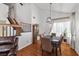 Elegant dining area with hardwood floors, stylish lighting, and a view of the backyard at 6746 Shelter Ln, Las Vegas, NV 89103