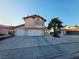Inviting two-story home featuring a two-car garage and a well-maintained front yard with mature landscaping at 6746 Shelter Ln, Las Vegas, NV 89103